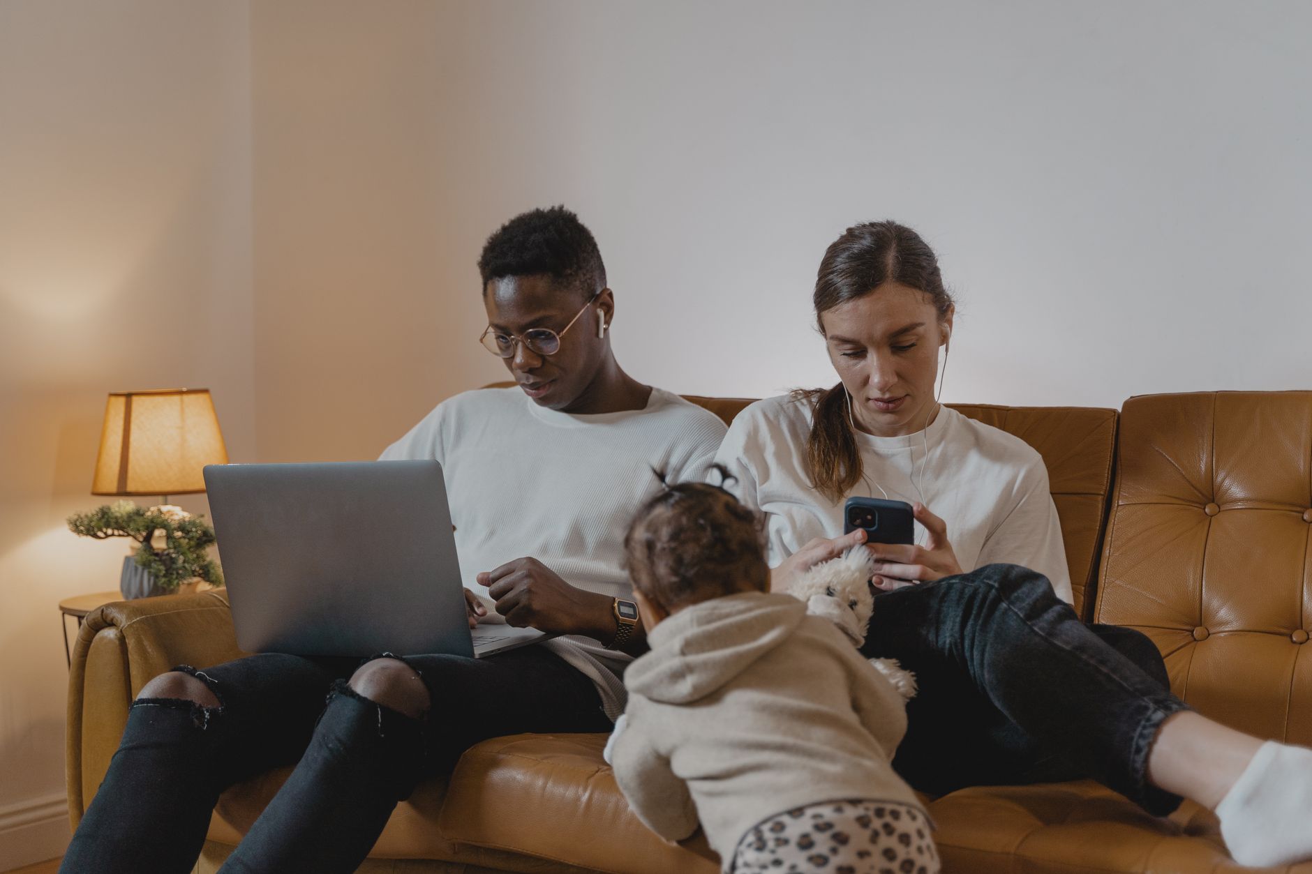 Family sitting in a dim living room while a phone charges from a battery
