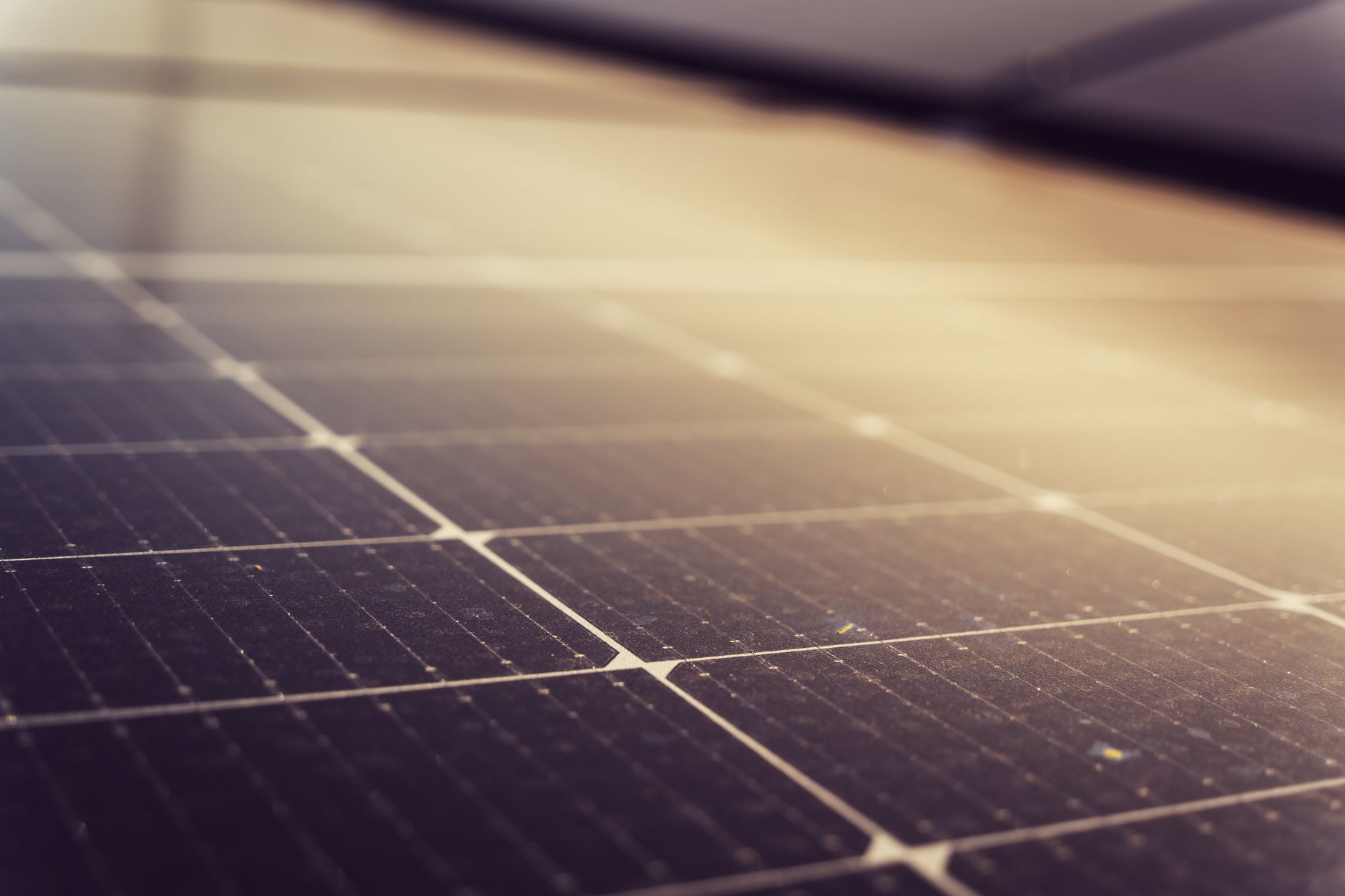 Portable solar panels charging a large battery power station on grass