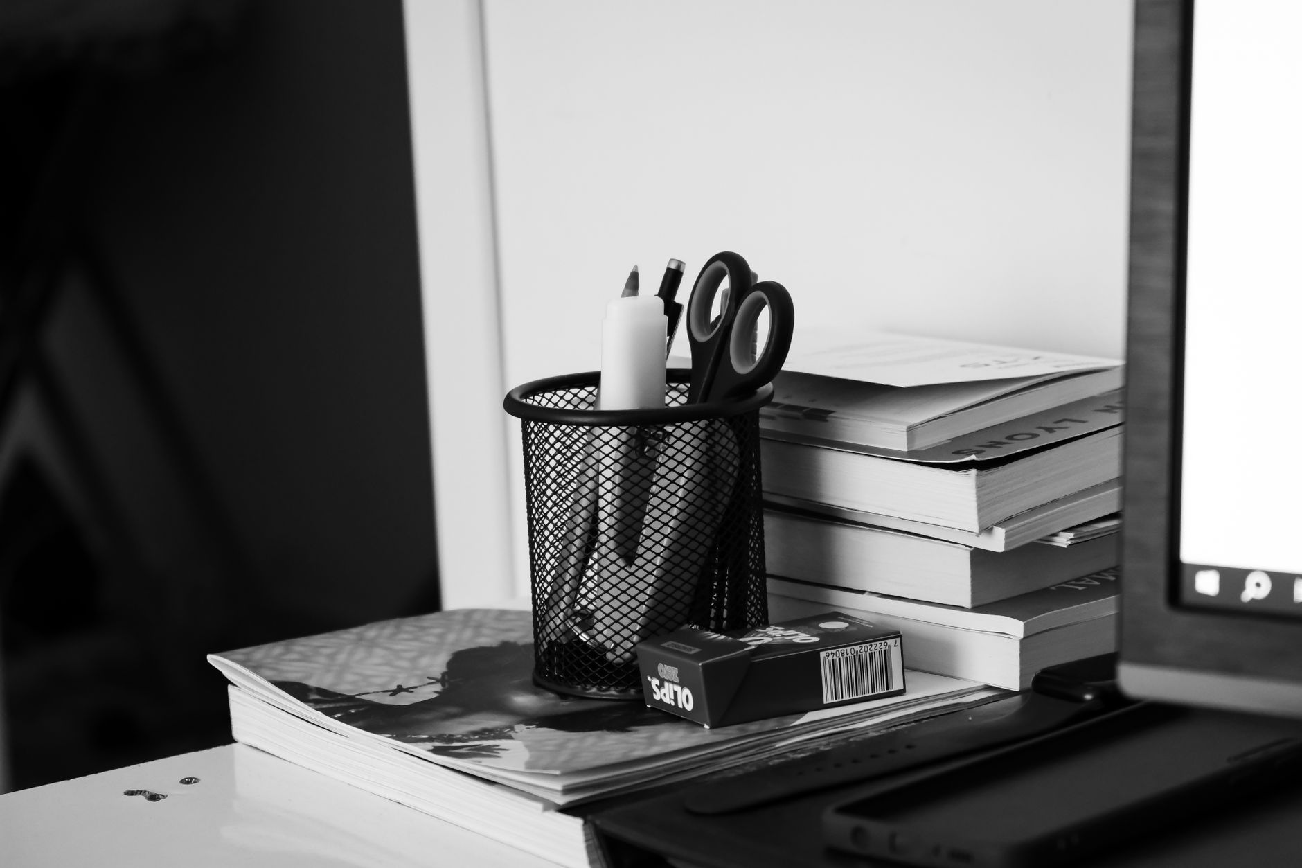 Black UPS unit with LCD display sitting beside a computer monitor on a desk