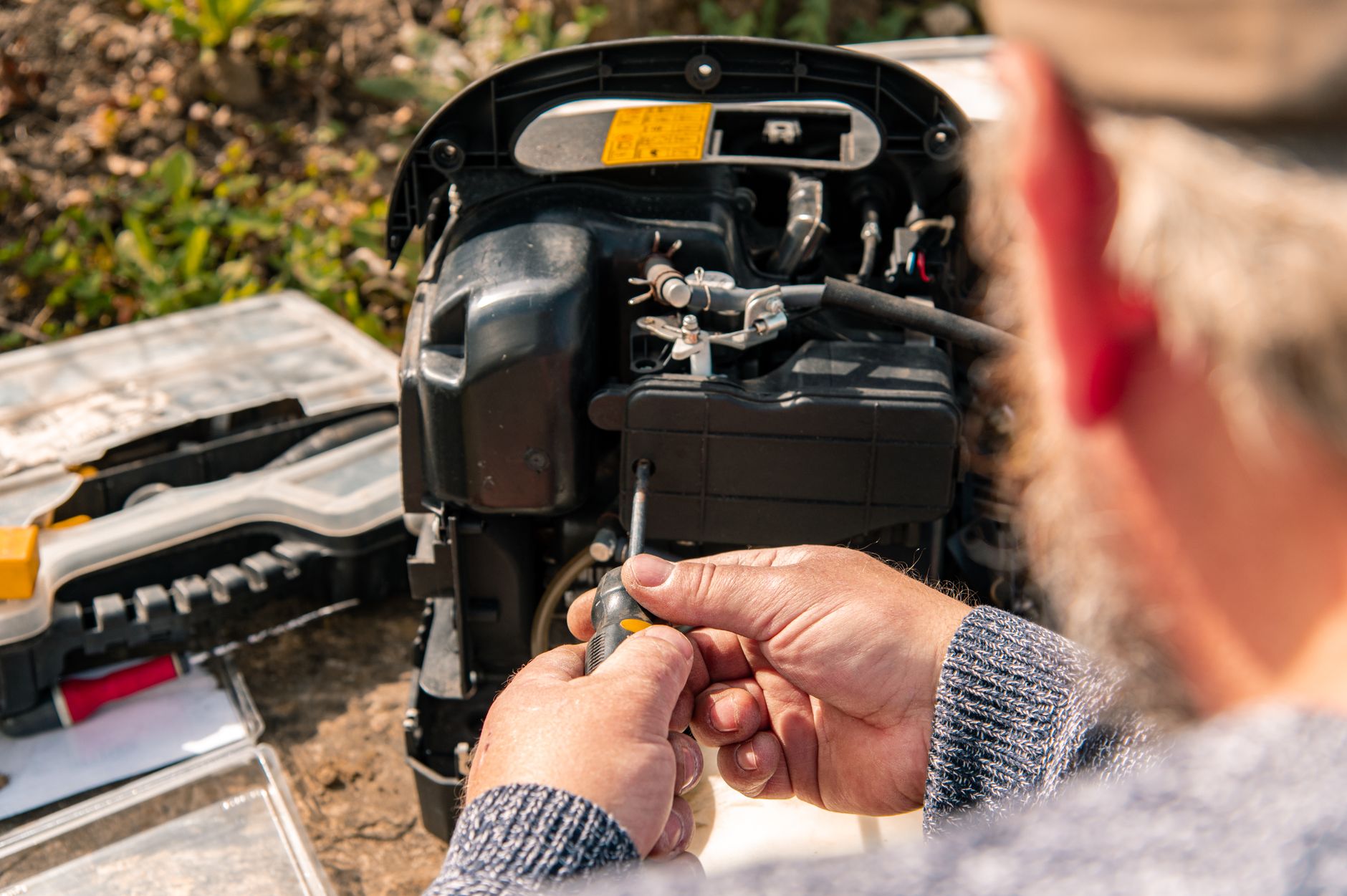 A portable generator running outdoors during a blackout with a CO detector nearby
