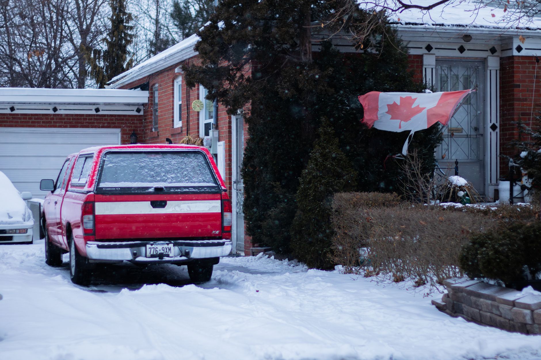 Generac standby generator outside a snowy Ontario home near the electrical meter