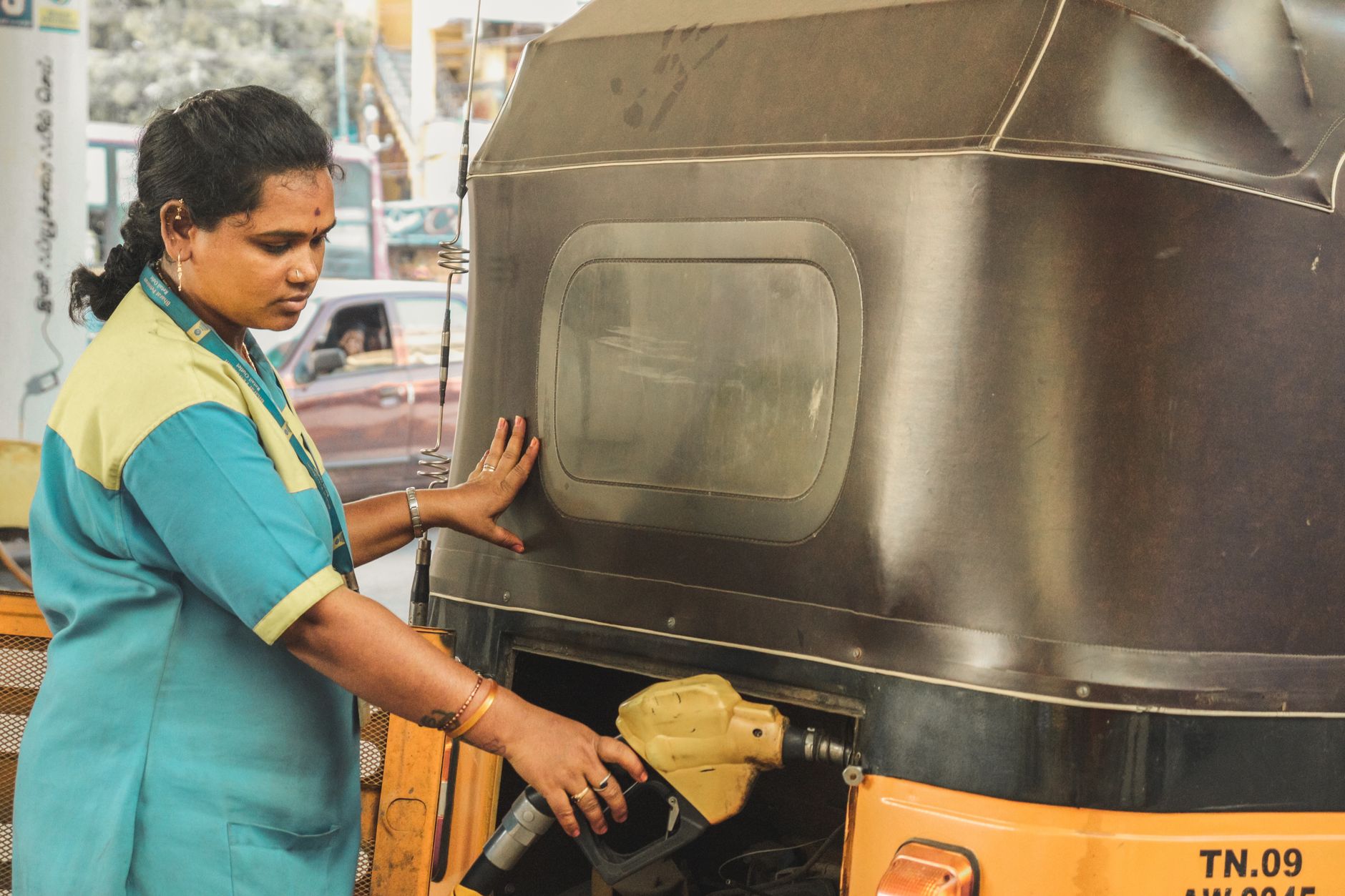 a person refuelling a portable generator outdoors
