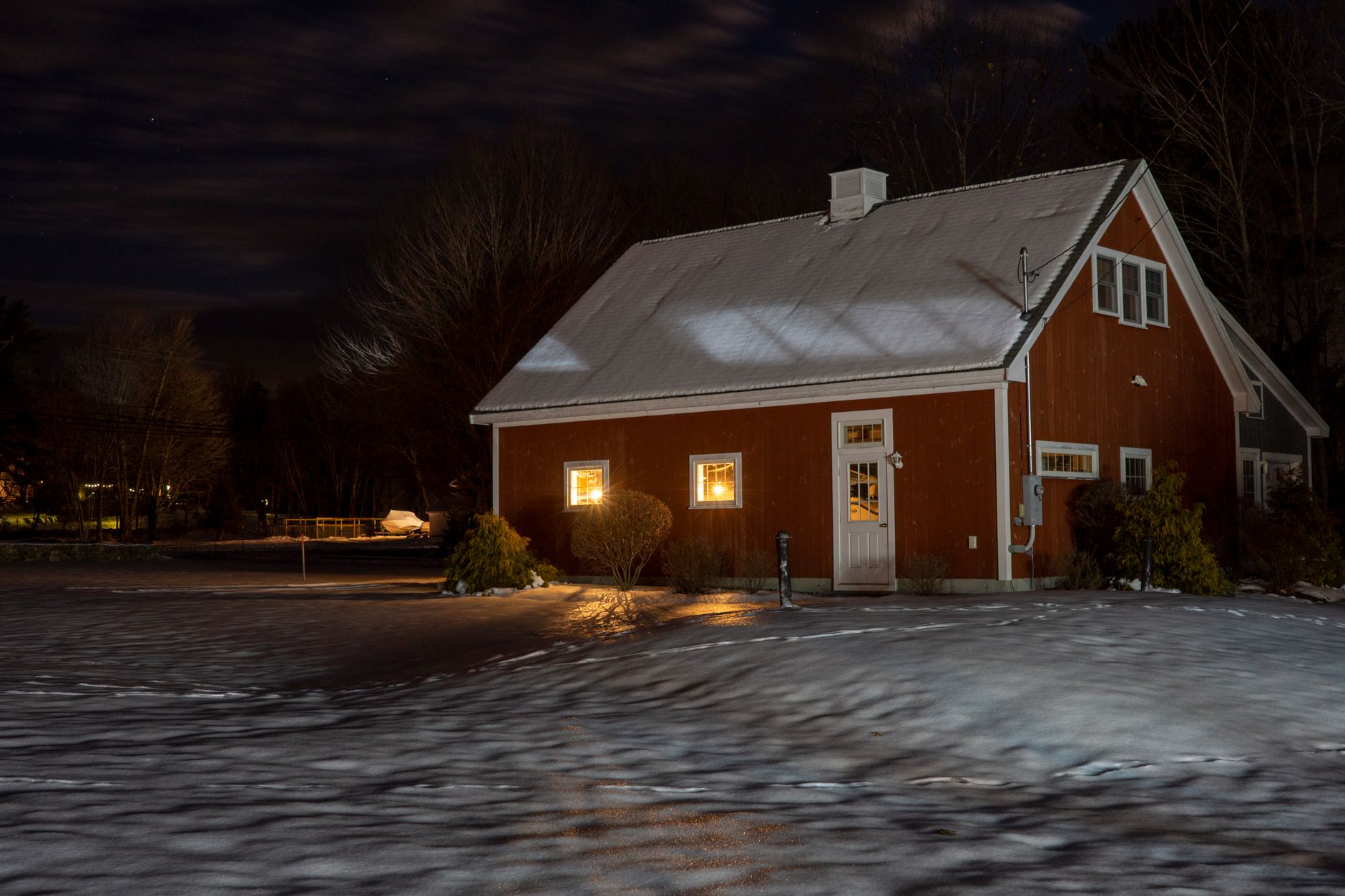 a portable generator sits outside a house in winter during a power outage