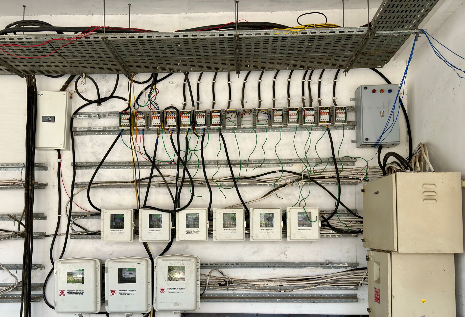 a licensed electrician wiring a generator transfer switch panel in a basement