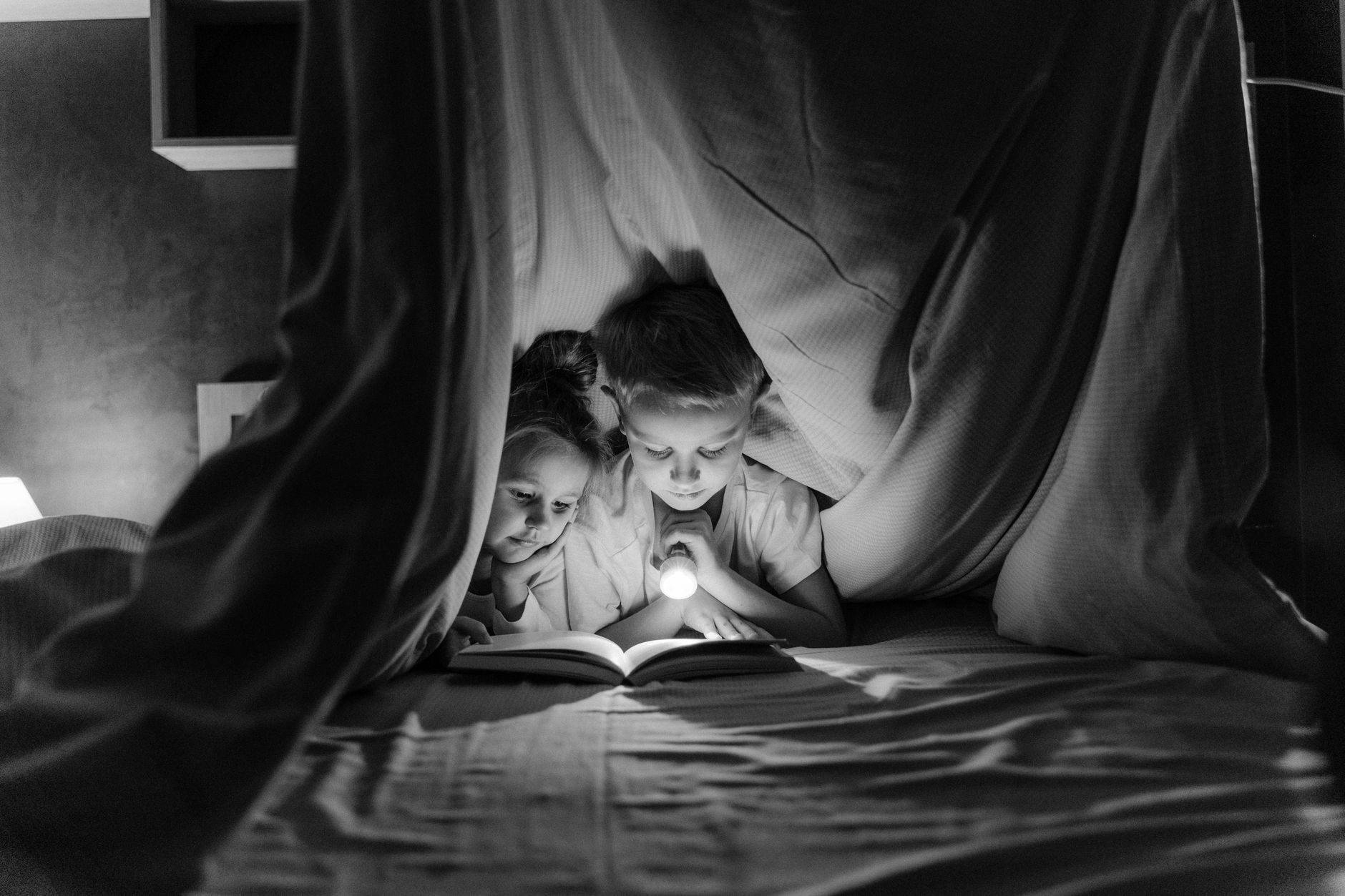 family staying warm under blankets during a power outage