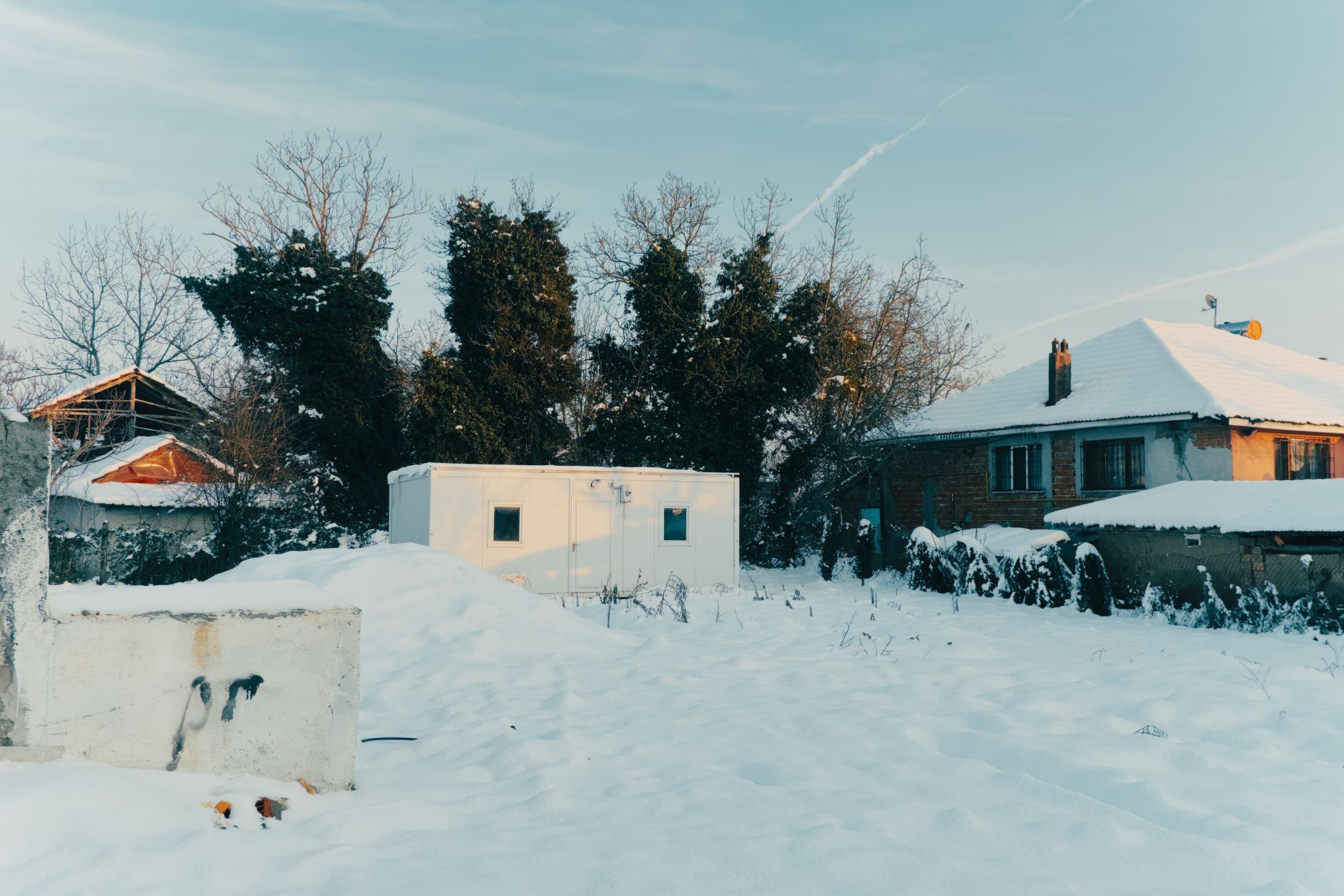 a generator running outside on a snowy driveway at least 20 feet from a Canadian home